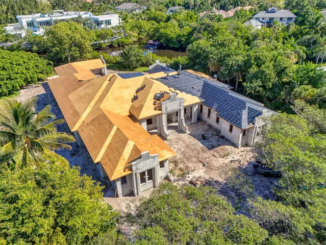 an aerial view of a house with a yard and trees