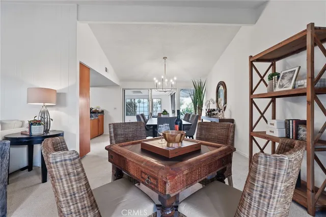 a living room with furniture a chandelier and a dining table