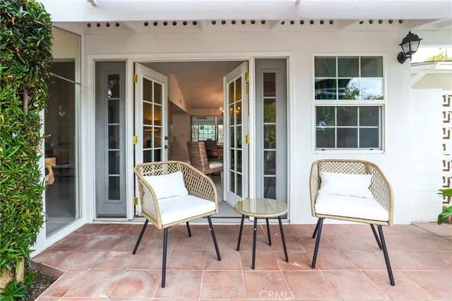a view of a porch with furniture and garden