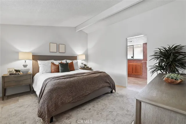 a bedroom with a large bed and a large window