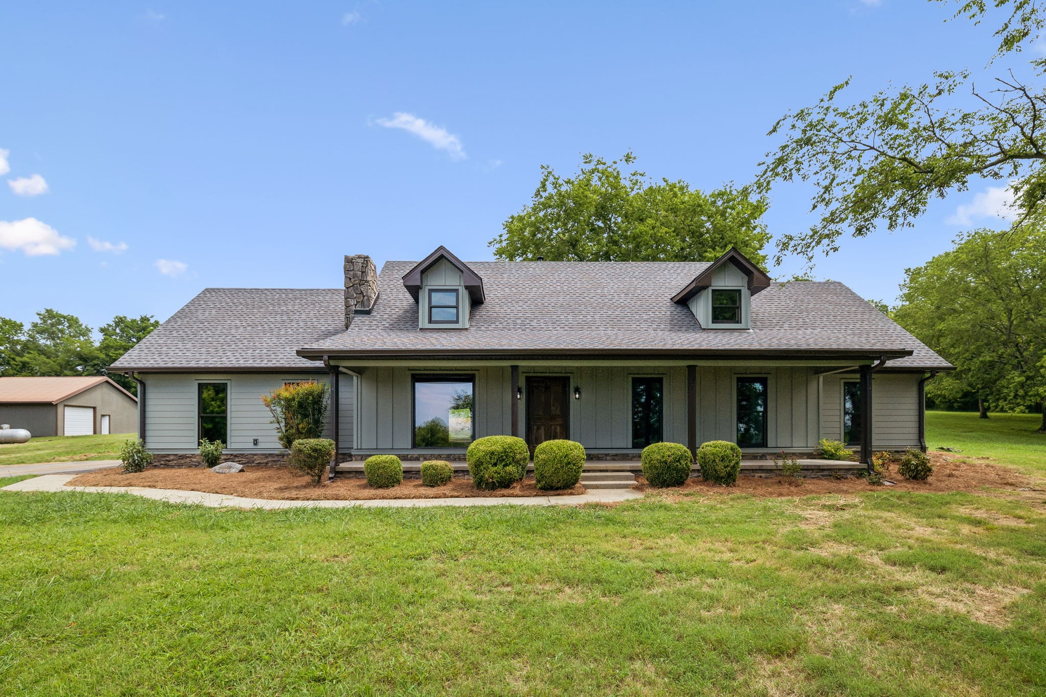 a front view of a house with garden