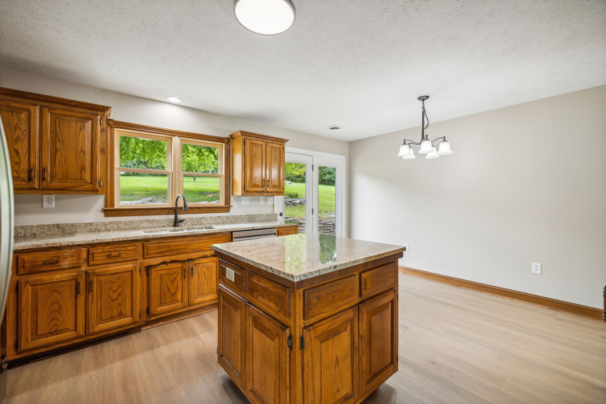 969 Trice Road Lebanon, TN 37087 - Photo 19 of 47 a kitchen with stainless steel appliances granite countertop a sink a stove and a wooden floors