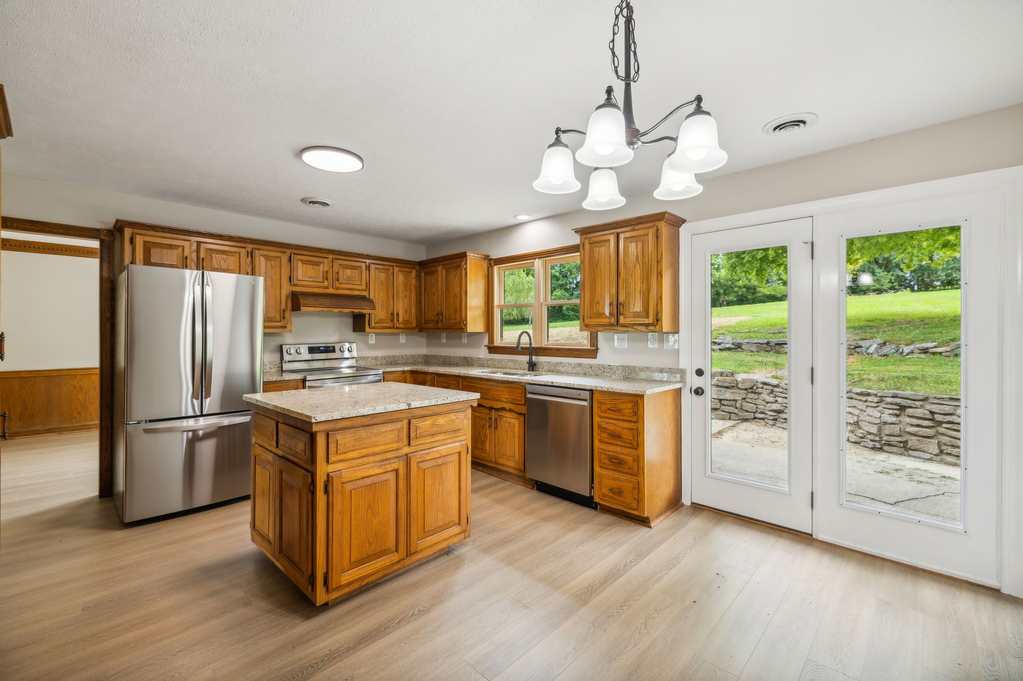 969 Trice Road Lebanon, TN 37087 - Photo 22 of 47 a kitchen with wooden floors and stainless steel appliances