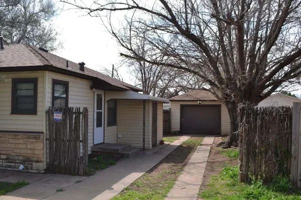 a front view of house with a garden