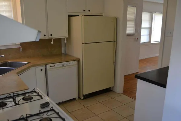 a kitchen with a stove a sink and a refrigerator