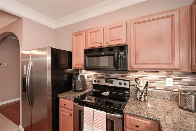 a kitchen with a stove microwave and refrigerator