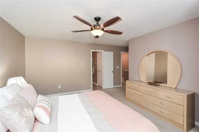 a bedroom with a large bed and a chandelier