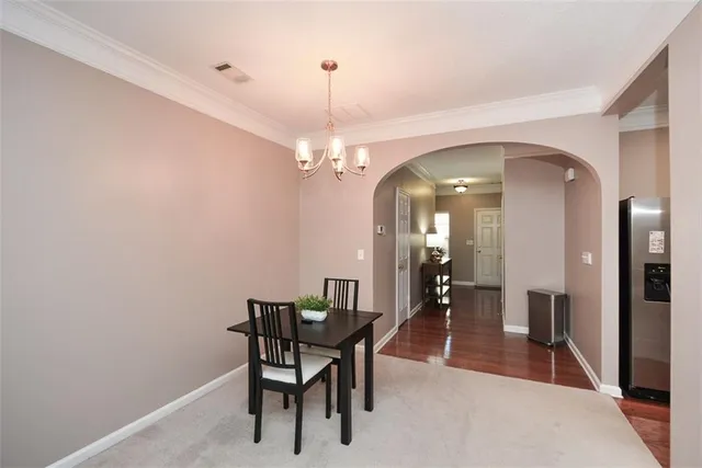 a view of a dining room with furniture and a chandelier