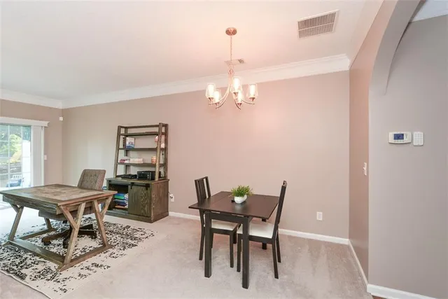 a view of a dining room with furniture and window