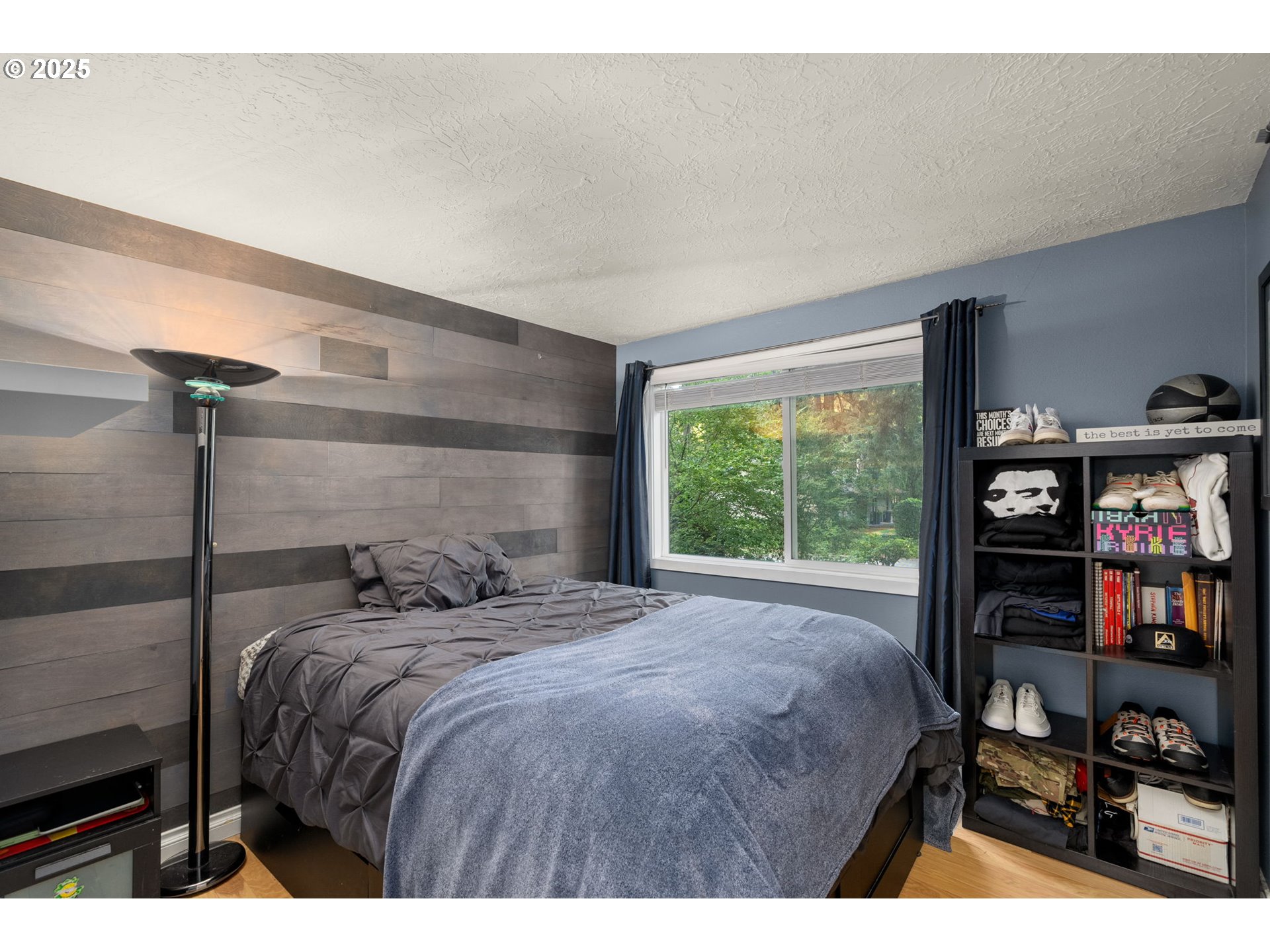 18863 Southwest Indian Springs Road Lake Oswego, OR 97035 - Photo 19 of 33 a bedroom with a bed a bookshelf and a window