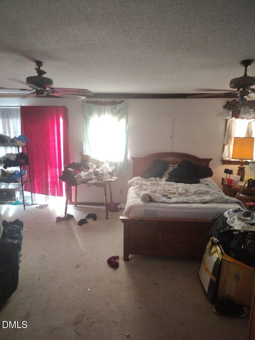 513 Pear Street Kinston, NC 28504 - Photo 7 of 11 a bed room with a bed and a tv