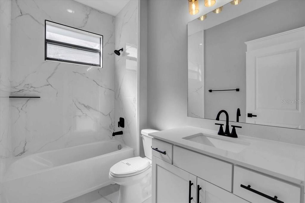 15159 Sea Salt Way Bradenton, FL 34211 - Photo 14 of 55 a bathroom with a sink a toilet and a bathtub