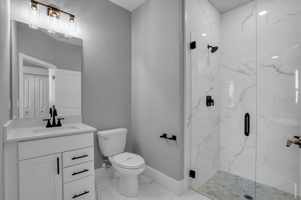 15159 Sea Salt Way Bradenton, FL 34211 - Photo 18 of 55 a bathroom with a toilet sink a shower and