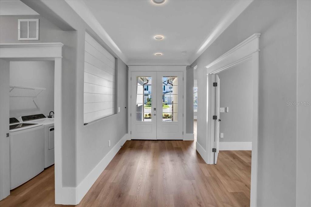 15159 Sea Salt Way Bradenton, FL 34211 - Photo 2 of 55 a view of a hallway with wooden floor and a bathroom
