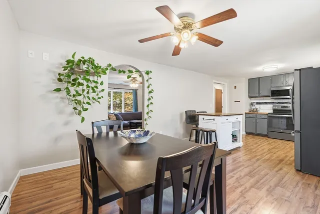 a view of a dining room with furniture and a kitchen