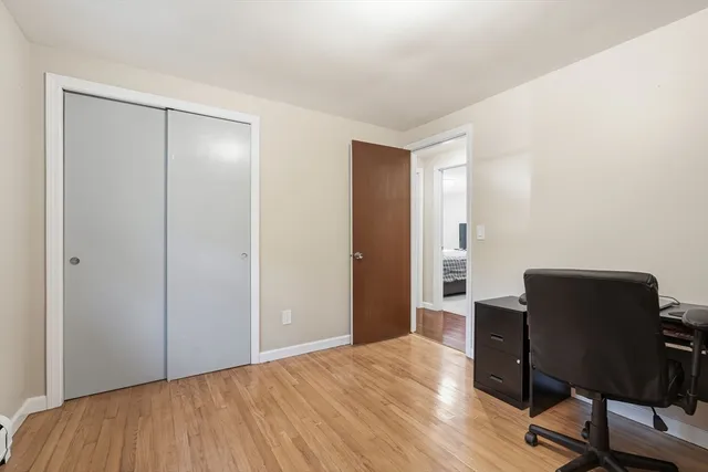 a view of a workspace with furniture and wooden floor