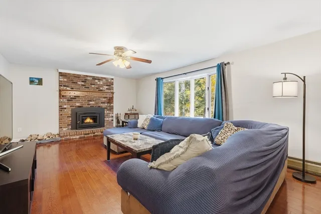 a living room with furniture a fireplace and a flat screen tv