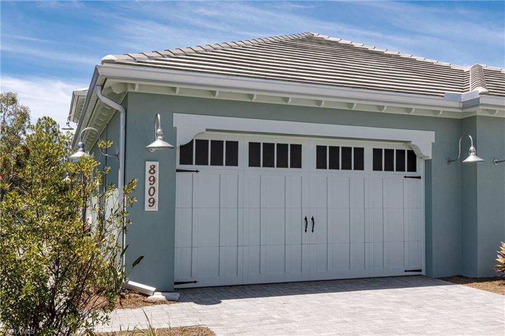 8909 Yucatan Court Naples, FL 34113 - Photo 18 of 36 Garage featuring decorative driveway