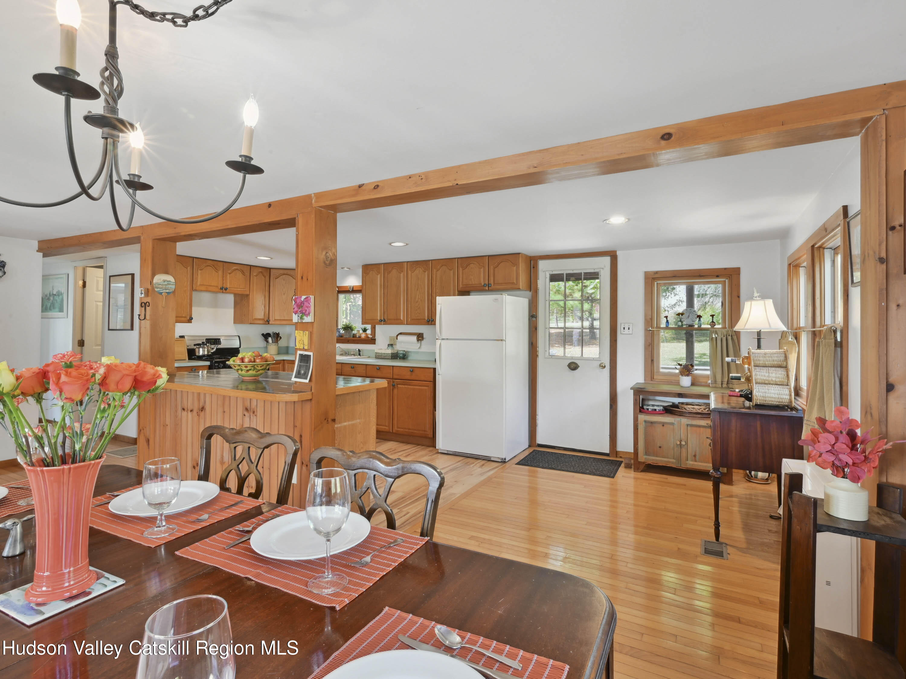 123 Maple Street Catskill, NY 12414 - Photo 13 of 47 a living room with furniture kitchen view and a chandelier