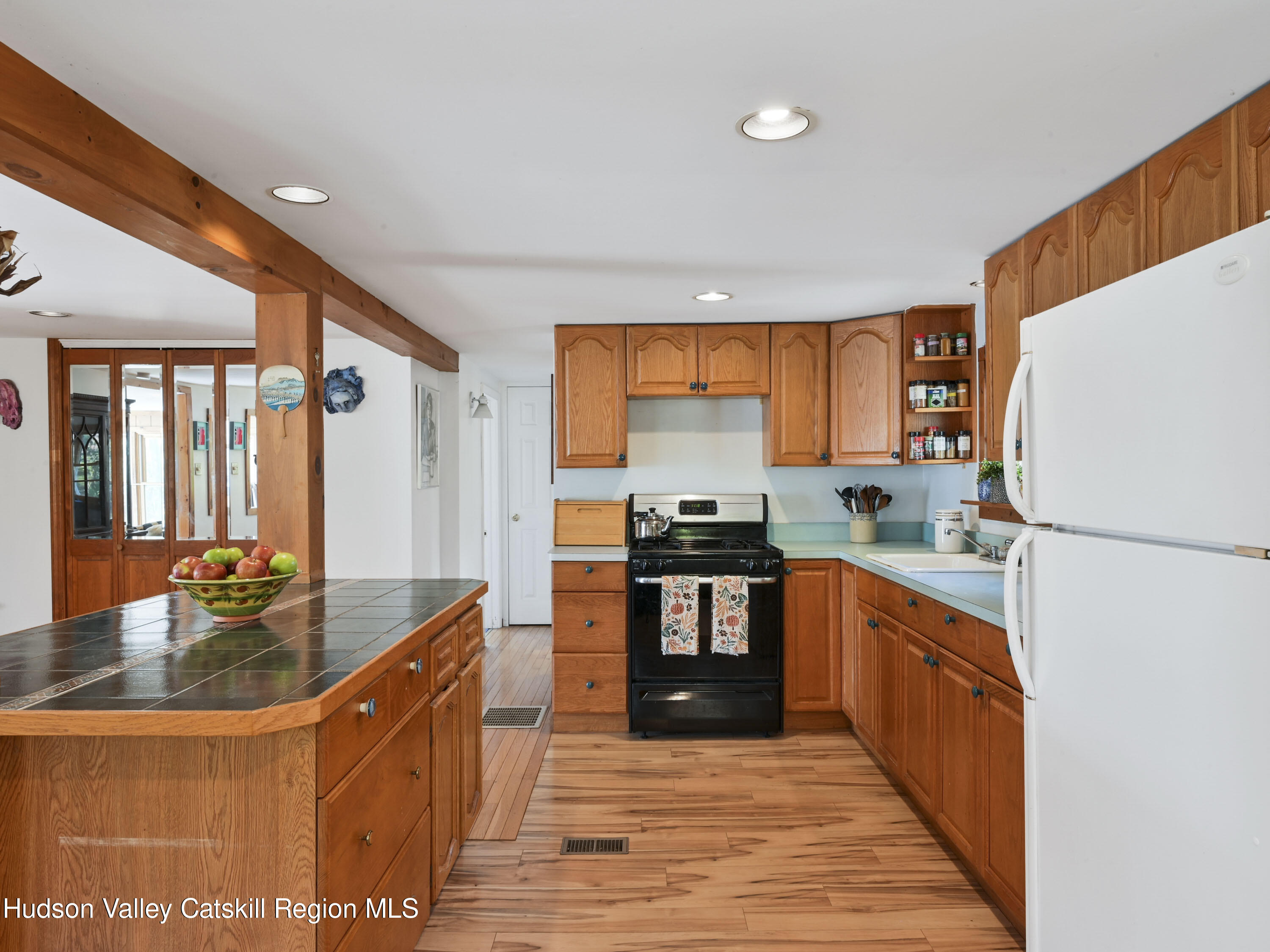 123 Maple Street Catskill, NY 12414 - Photo 19 of 47 a kitchen with stainless steel appliances granite countertop a refrigerator a stove and a sink with wooden floors