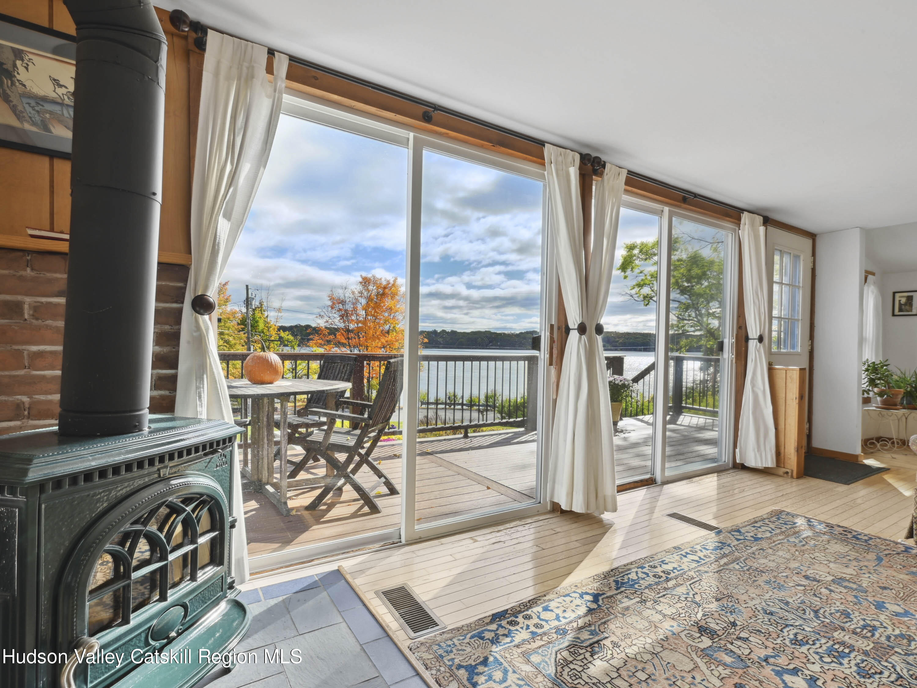 123 Maple Street Catskill, NY 12414 - Photo 3 of 47 a view of a living room with a floor to ceiling window and wooden floor