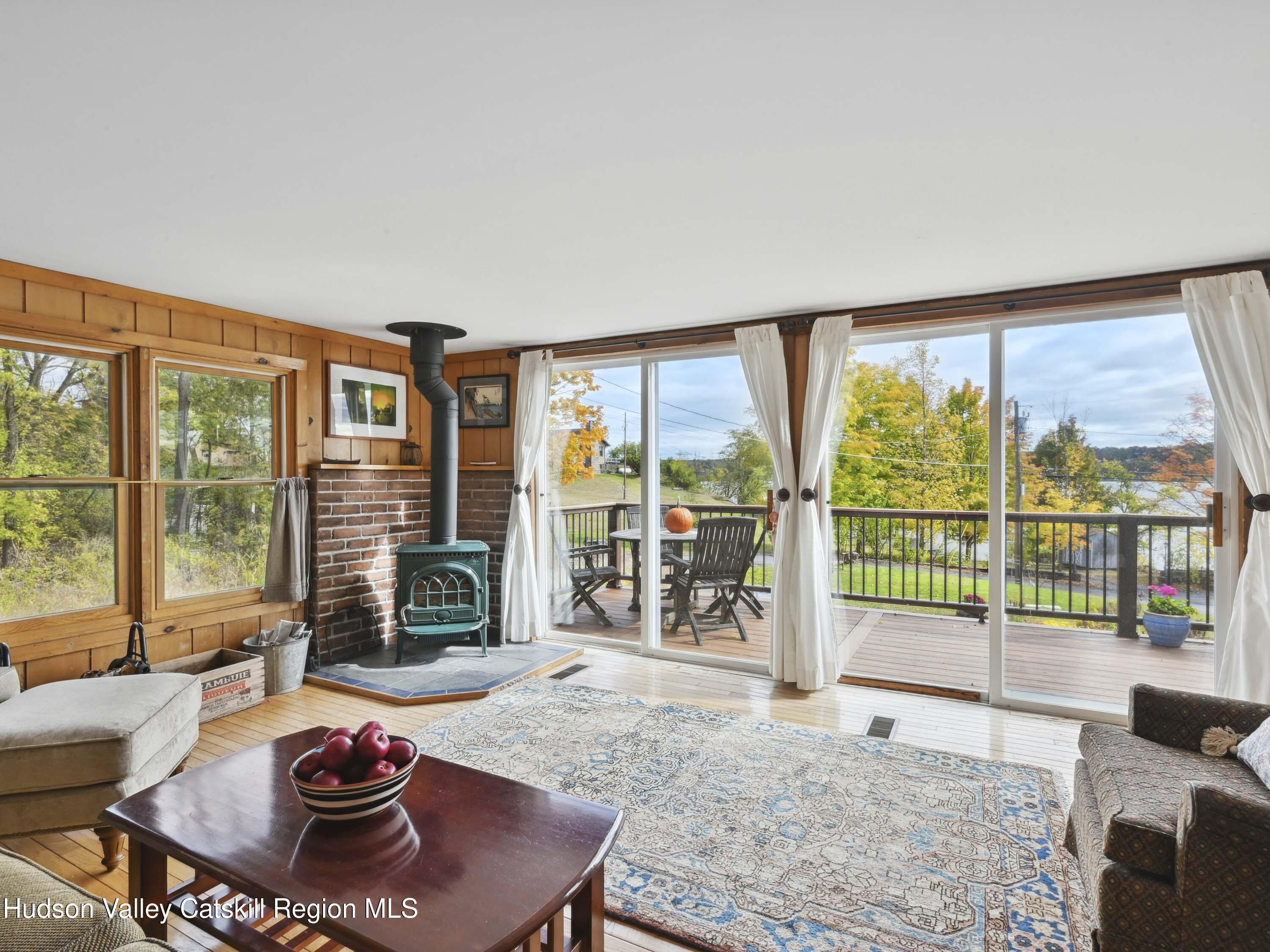 123 Maple Street Catskill, NY 12414 - Photo 6 of 47 a living room with furniture and a floor to ceiling window