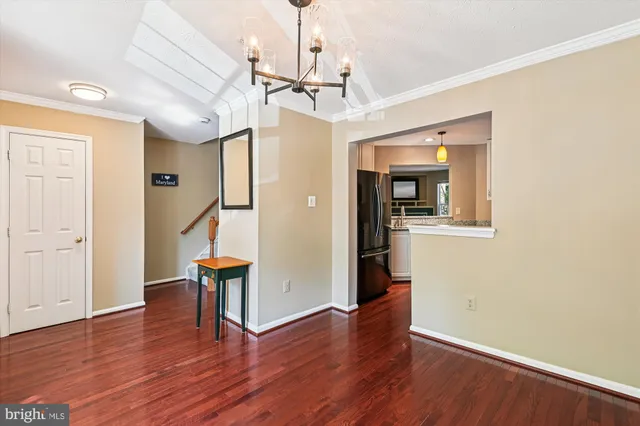 a view of entryway with wooden floor and stairs