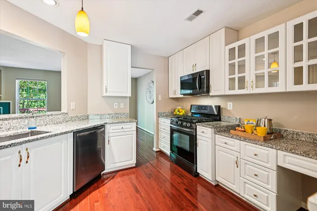 a kitchen with stainless steel appliances granite countertop a stove and a sink