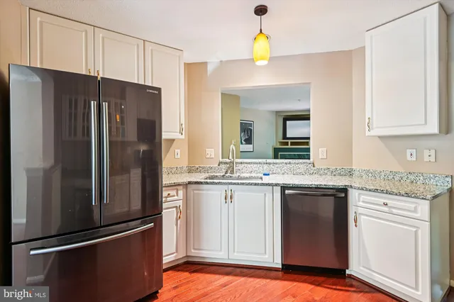 a kitchen with stainless steel appliances granite countertop a sink and cabinets