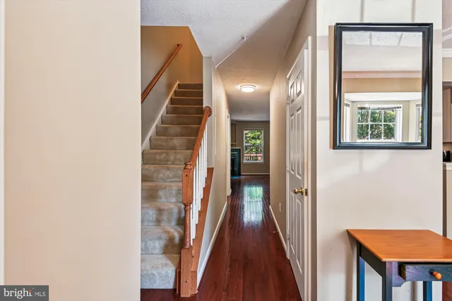 a view of a hallway with wooden floor and entryway