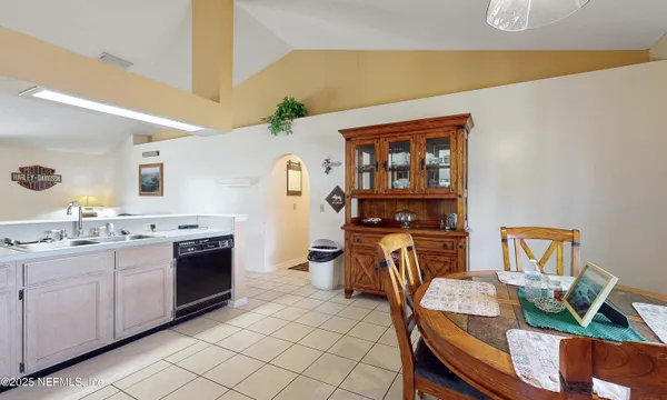 a view of kitchen with sink dining table and chairs