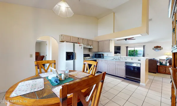 a kitchen that has a table and chairs in it