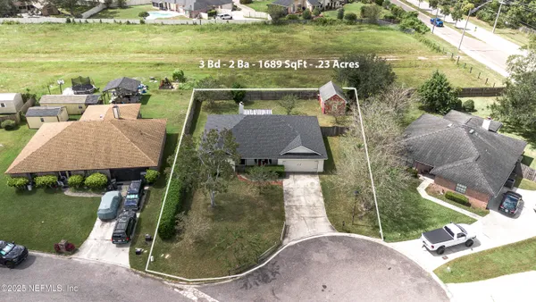 an aerial view of a house with outdoor space