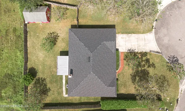 aerial view of a house with a yard