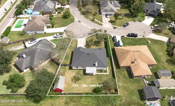 an aerial view of residential houses with outdoor space