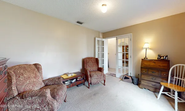 a bedroom with furniture and a window