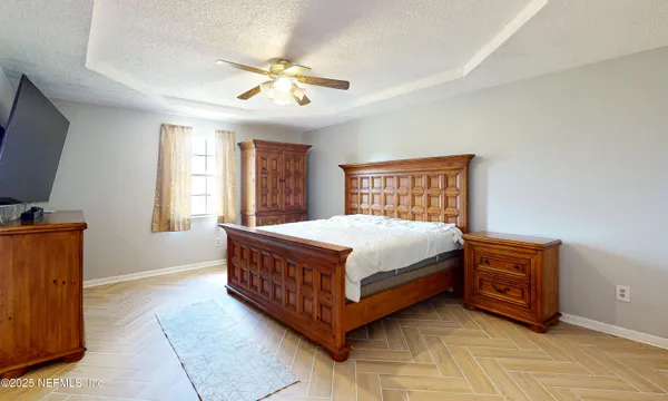 a bed sitting in a room next to a window