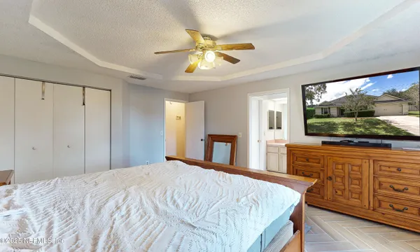 a bedroom with a bed and a flat screen tv