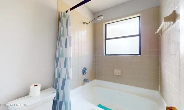 a bathroom with a bathtub and shower