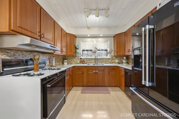 a kitchen with stainless steel appliances granite countertop a stove refrigerator sink and cabinets