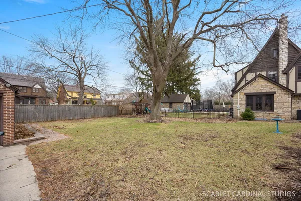 a view of a yard with a house and a tree