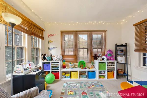 a living room filled with furniture and a floor to ceiling window