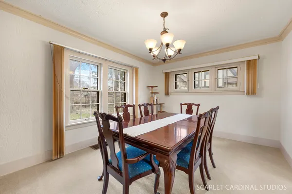 a view of a dining room with furniture a chandelier and wooden floor