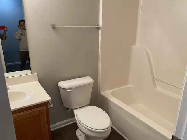a white toilet sitting next to a bathroom sink