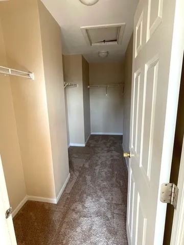 a spacious bathroom with a granite countertop sink mirror and a bathtub