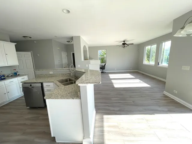 a view of a livingroom with a fireplace and window