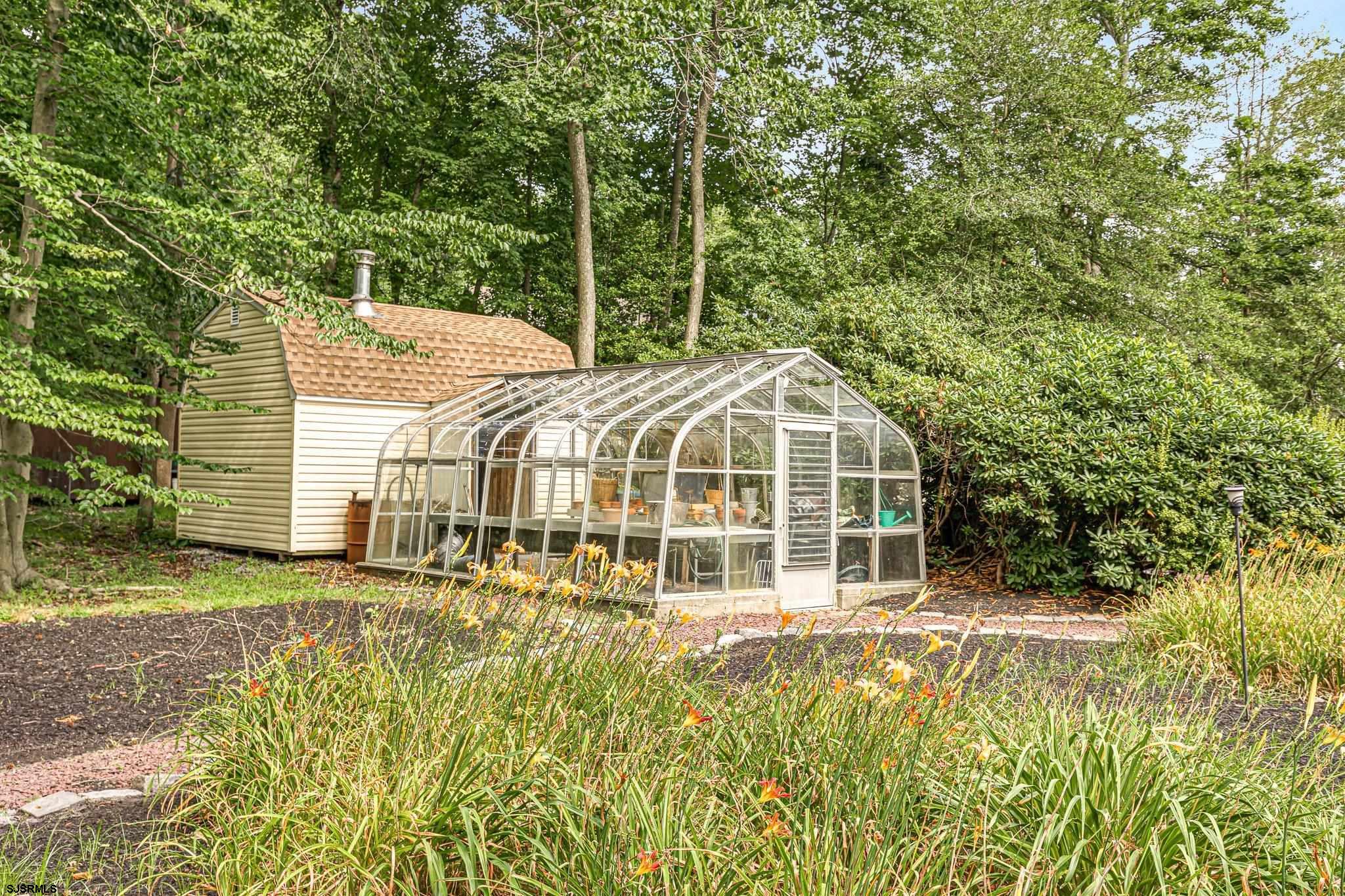 108 Weatherby Road Mullica Hill, NJ 08062 - Photo 16 of 18 a front view of a house with a garden