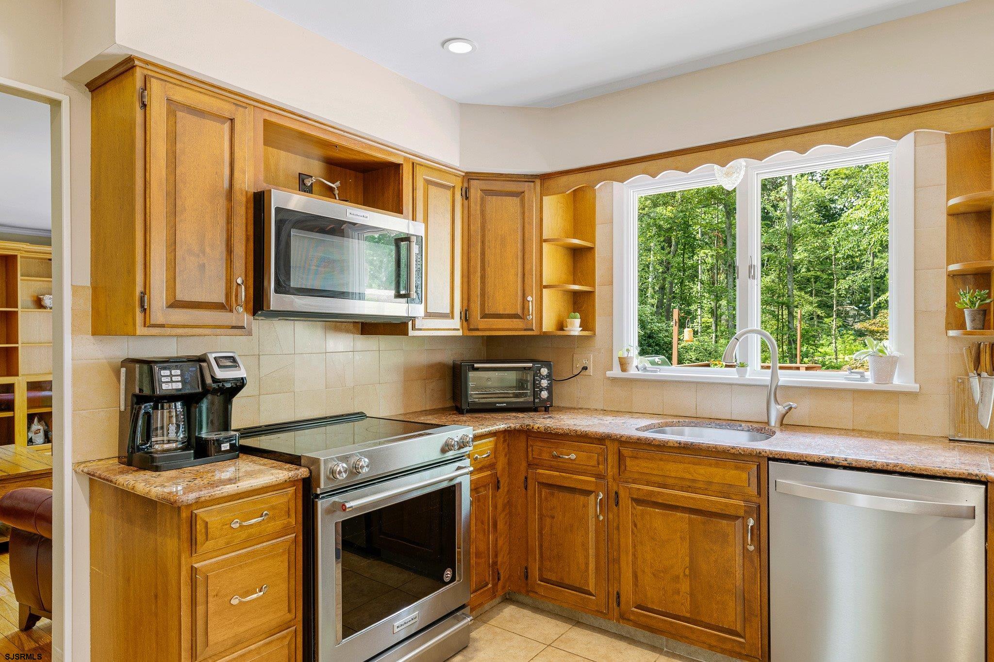 108 Weatherby Road Mullica Hill, NJ 08062 - Photo 3 of 18 a kitchen with stainless steel appliances granite countertop white cabinets a stove top oven a sink and dishwasher with wooden floor