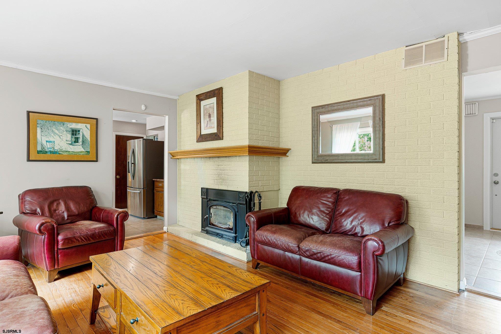 108 Weatherby Road Mullica Hill, NJ 08062 - Photo 6 of 18 a living room with furniture or couch and a fireplace