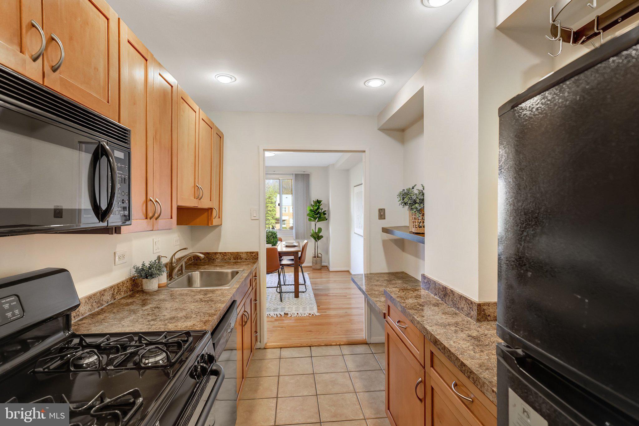 1900 Lyttonsville Road, Unit 504 Silver Spring, MD 20910 - Photo 6 of 16 a kitchen with granite countertop a stove and a sink